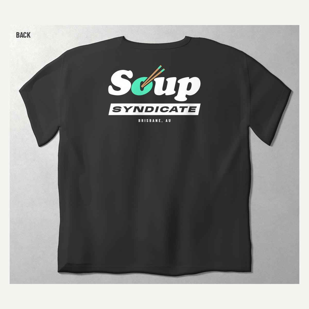 Soup Syndicate Big Lockup tee in washed black, back view with the big Soup SYNDICATE lockup and BRISBANE, AU